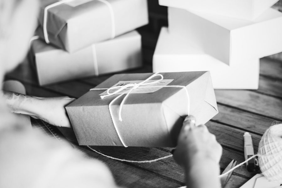 Woman wrapping a package by herself