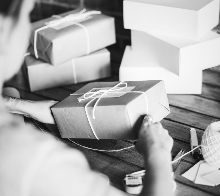 Woman wrapping a package by herself